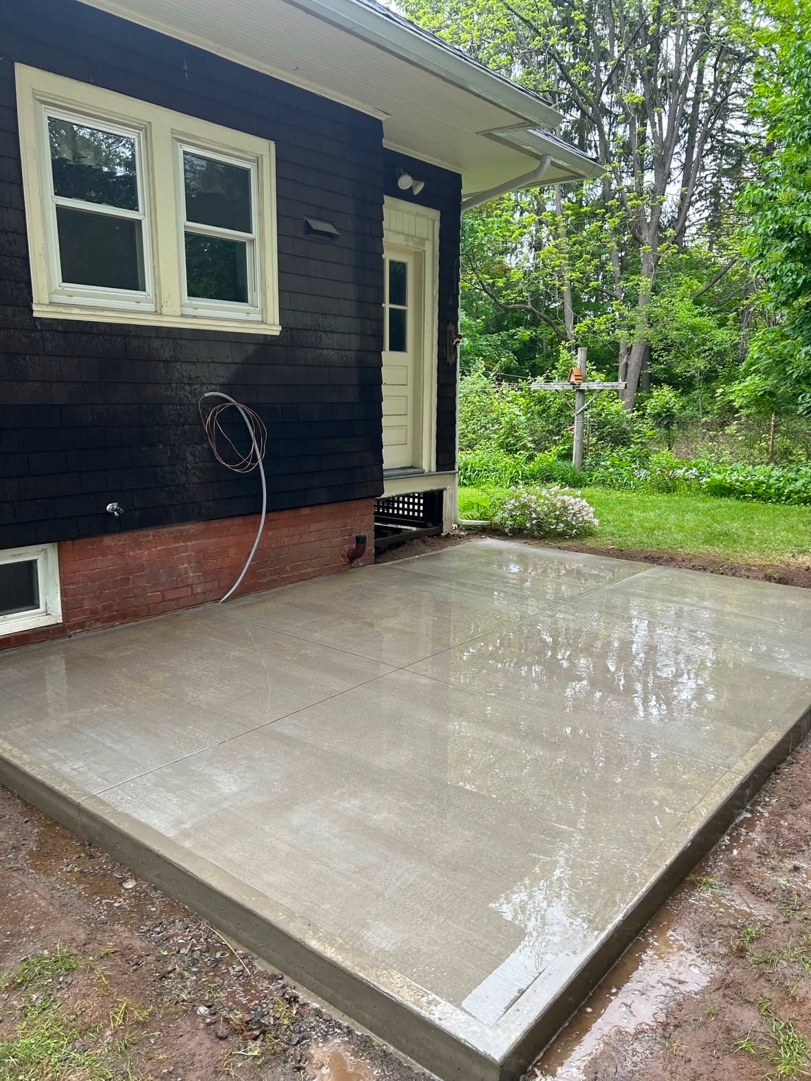 Fresh concrete patio beside a home