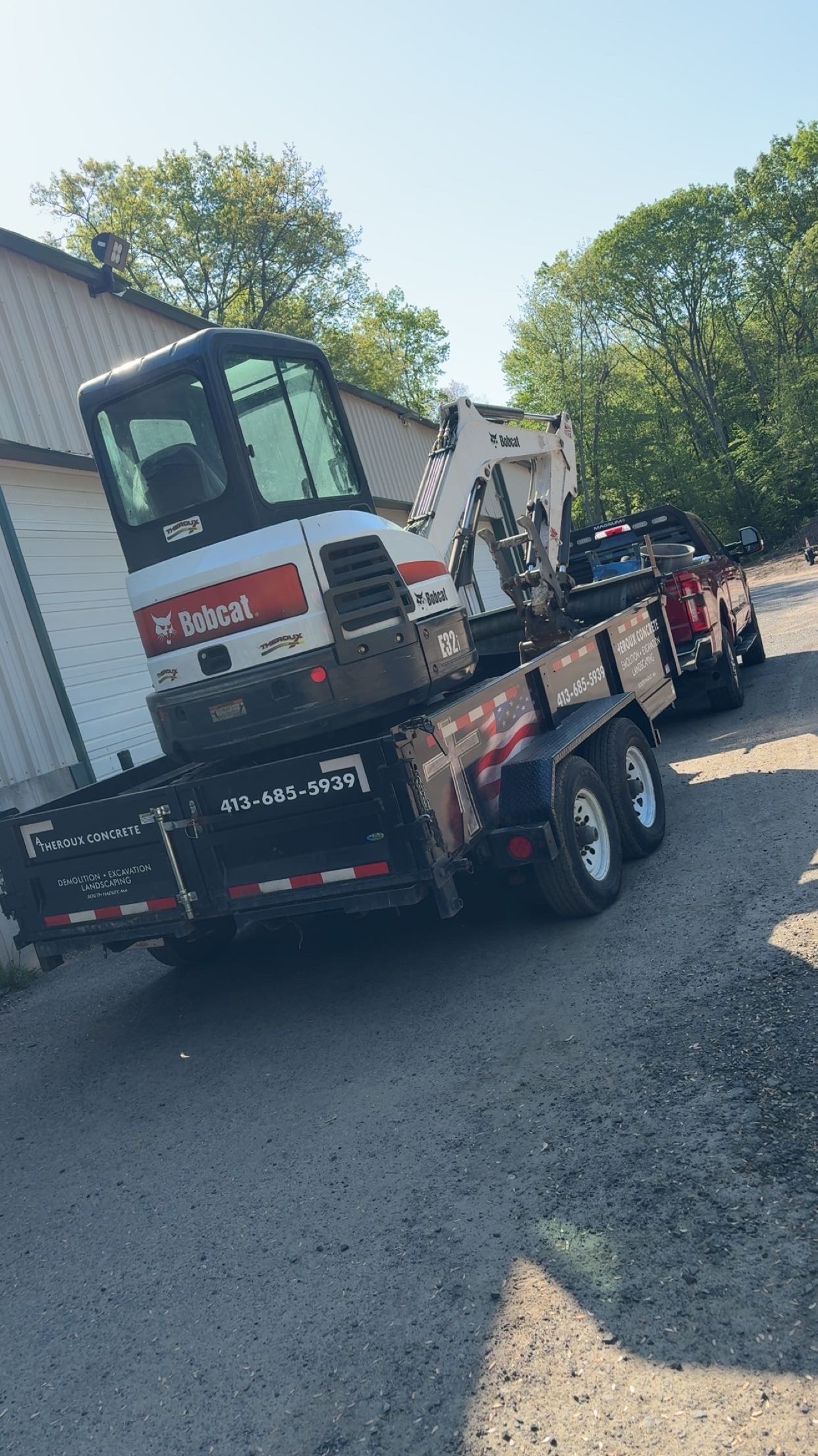 Bobcat excavator loaded on A. Theroux Concrete trailer